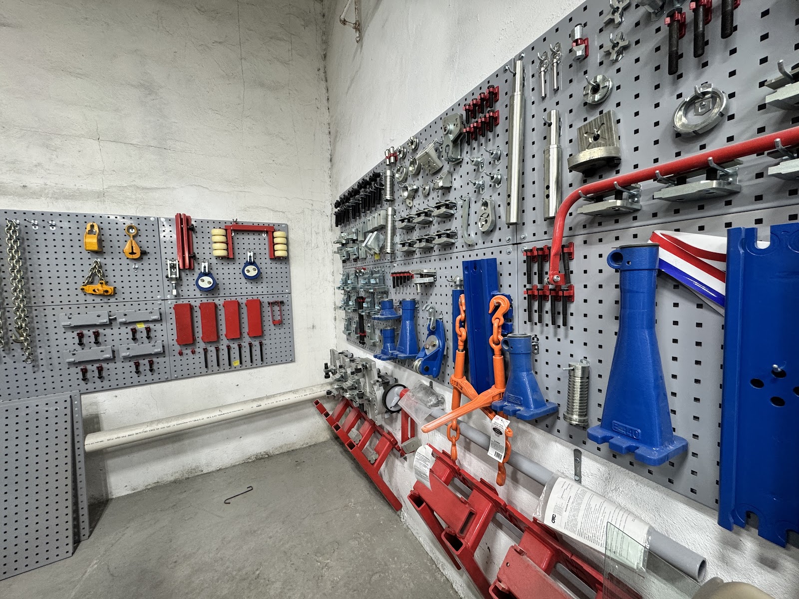 Frame-straightening clamps and tools arranged on the shop wall
