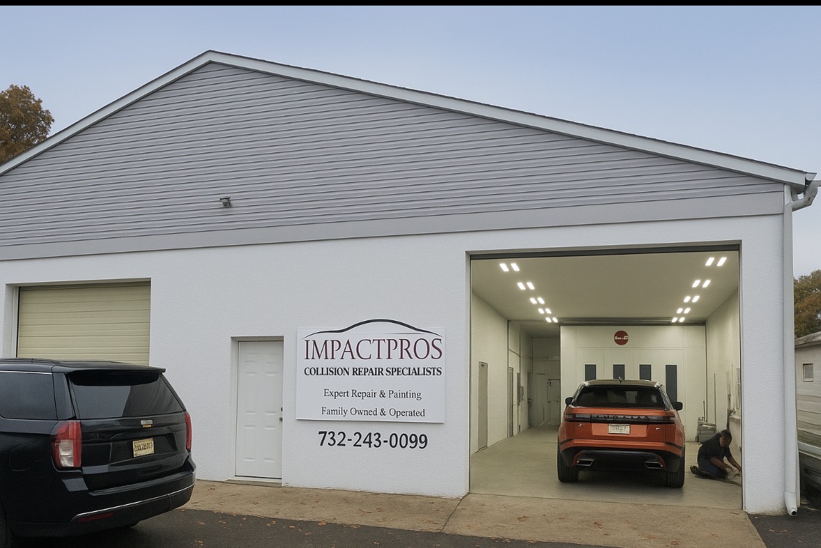 Impact Pros' building with its sign and open repair bay